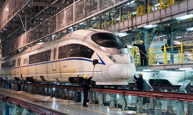 Workers check bullet trains before Spring Festival travel rush