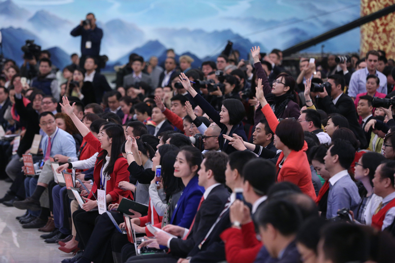 3月15日，國務院總理李克強在北京人民大會堂與中外記者見面，并回答記者提問。這是記者舉手爭取提問機會。 新華社記者 才揚 攝